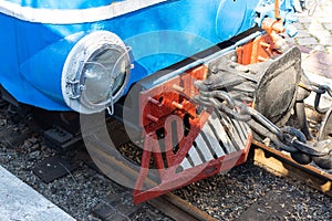 The front body of the railway carriage is blue. Headlight of a train close-up.