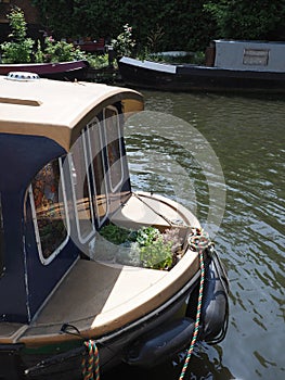 The front ,bow, of a widebeam canal boat on the Regents Canal moored near Kings Cross, London