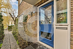 the front of a brick house with a blue door