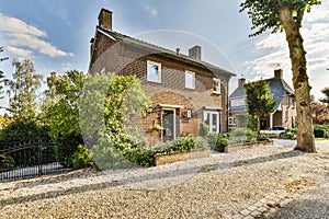 the front of a brick house with a gravel driveway