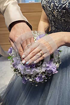 In front of the bride and groom's ring cut bouquet