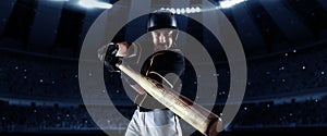 Front camera view of of professional baseball player with baseball bat in action during match in crowed sport stadium at