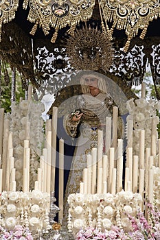 Front with candles, embroidered fabric and flowers of the throne of the Nuestra Senora del Amor Hermoso