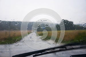 Front car window glass and wipers during heavy rain