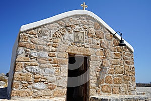 The Front of the Church of Prophet Elias with a restored simple bell. Pefkos or Pefki, Rhodes Island, Greece