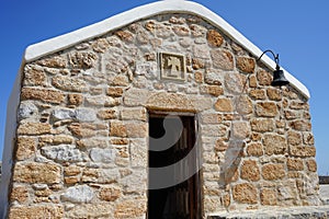 The Front of the Church of Prophet Elias with a restored simple bell. Pefkos or Pefki, Rhodes Island, Greece