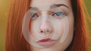 Front close up portrait of redhead teenage young girl attractive woman beautiful stylish model with blue eyes posing