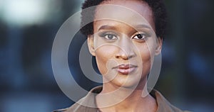 Front closeup portrait of young mixed race beauty African American black woman with short hair afro style standing on