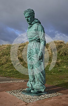 The front of the Copper Clad Minesweeper Statue at Montrose Beach, depicting a Man who patrolled the Wartime Beaches of Scotland.