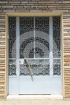 Front door with glass panels and metal grates