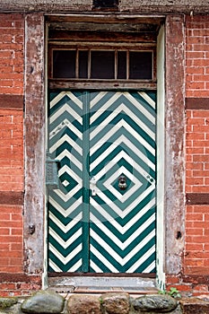 Front door with green and white pattern in an old house