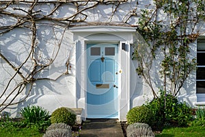 the front door of an old english cottage with ivy growing around the door