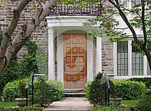 Front door with portico and shady front yard