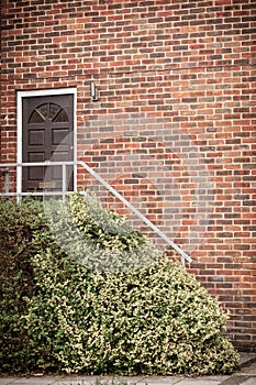 Front door of red brick house