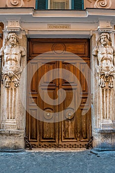 Front door of a Roman building near Spagna Square in Rome, Italy