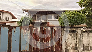 Front door with rusty surface and behind are neighbour house