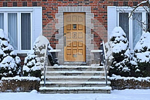 Front door and snow covered shrubbery photo