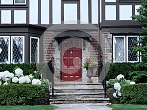 Front door of traditional two story Tudor style house