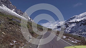 FRONT DRIVING PLATE Car driving on road snowy landscape towards mountains snow green hill india