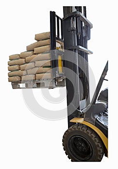 The front end of the forklift is lifting bags of cement on the pallet