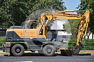 Front end loader excavator at the road construction