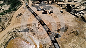 Front-end loader loading sand it to the freight train. Mining work in a quarry