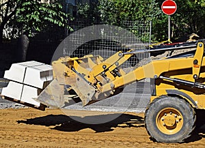 Front end loader at the road construction
