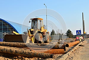 Front-end loader working on construction site during the renovation of the road.