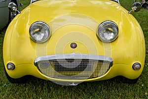 Front end of a yellow Austin-Healey Sprite