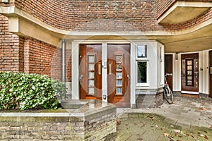 the front entrance of a brick house with two doors