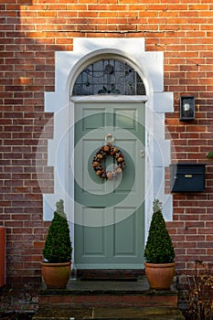 The front entrance of an english country home decorated for Christmas