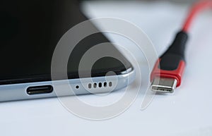 Front entrance of USB-C cable plug and port on smartphone