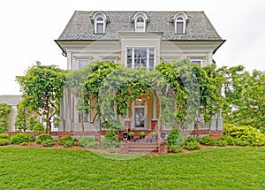 front entrance Wistariahurst historic house museum and green plants and lawn