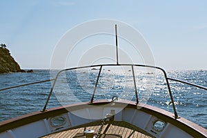 Front facade on a recreation boat cruising across the Mediterranean Sea on a bright sunny summer day