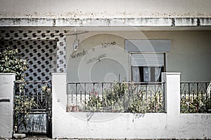 Front facade of a residential house identified with the phrase, "Vivenda o Nosso Sacrificio" photo