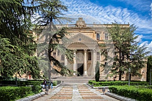 Front facade view at the Faculty of Philology at the University of Salamanca and park and garden surround photo