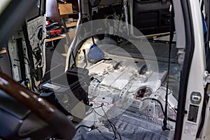 The front floor part car inside the hull of the white SUV on the driver`s side with the trim removed and the interior elements,