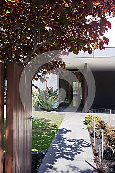 Front gate opening to show a beautiful contemporary home