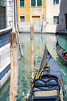 Front of a gondola parked on the canal on a summer day.