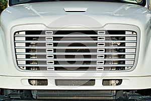 Front grille of a generic white truck.