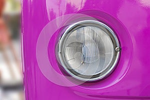 The front headlight of the vintage prestigious car.