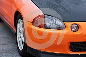 Front headlight and wheel of a sports car