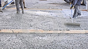 In front of home mixer truck pours wet cement ready mixed concrete for a driveway