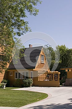 Front of a House and its Driveway with Blue Skies on the Background