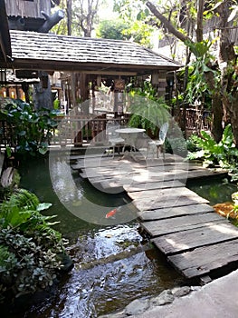 In front of the house there is a walkway and a fish pond