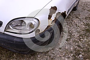 The front lamp of the white car broken by the accident.