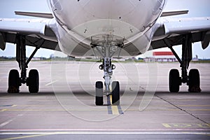 Front landing gear of big passenger aircraft closeup high detailed view