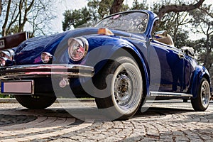 Front-left side view of navy blue classic convertible car