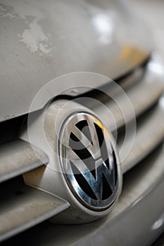 Front logo of a parked silver colored Volkswagen Golf Plus 2006 in a parking lot