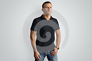 Front mockup black polo shirt on a muscular man isolated on a
